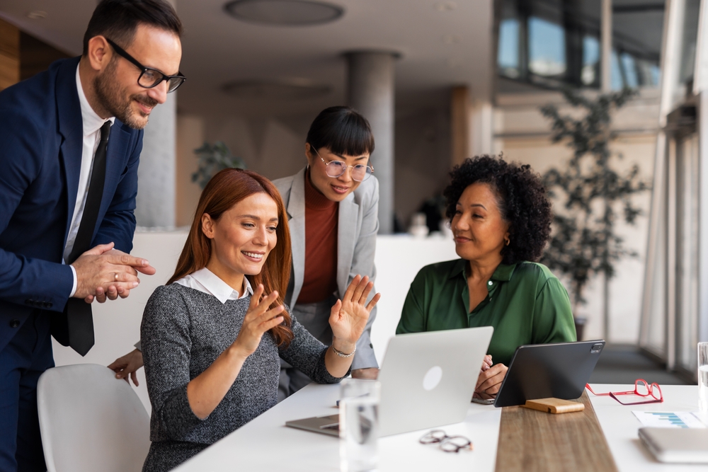 Colleagues,In,A,Modern,Office,Smiling,And,Discussing,Ideas,While